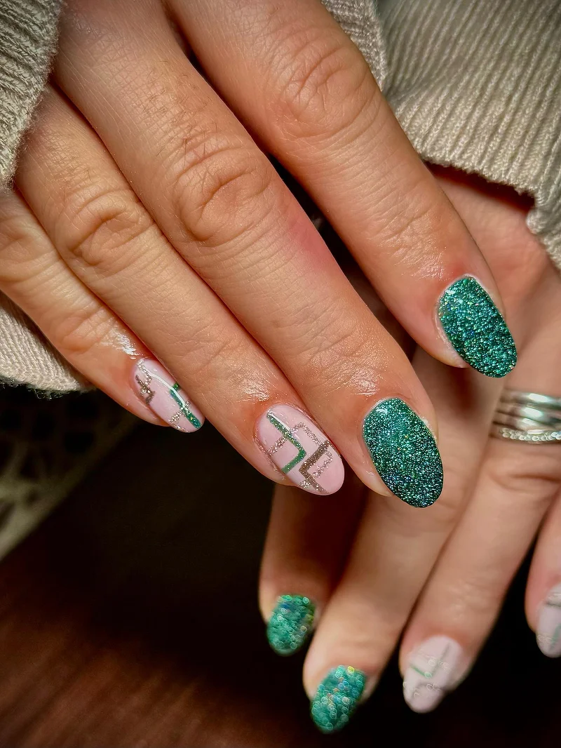 Emerald green glitter nails with geometric design