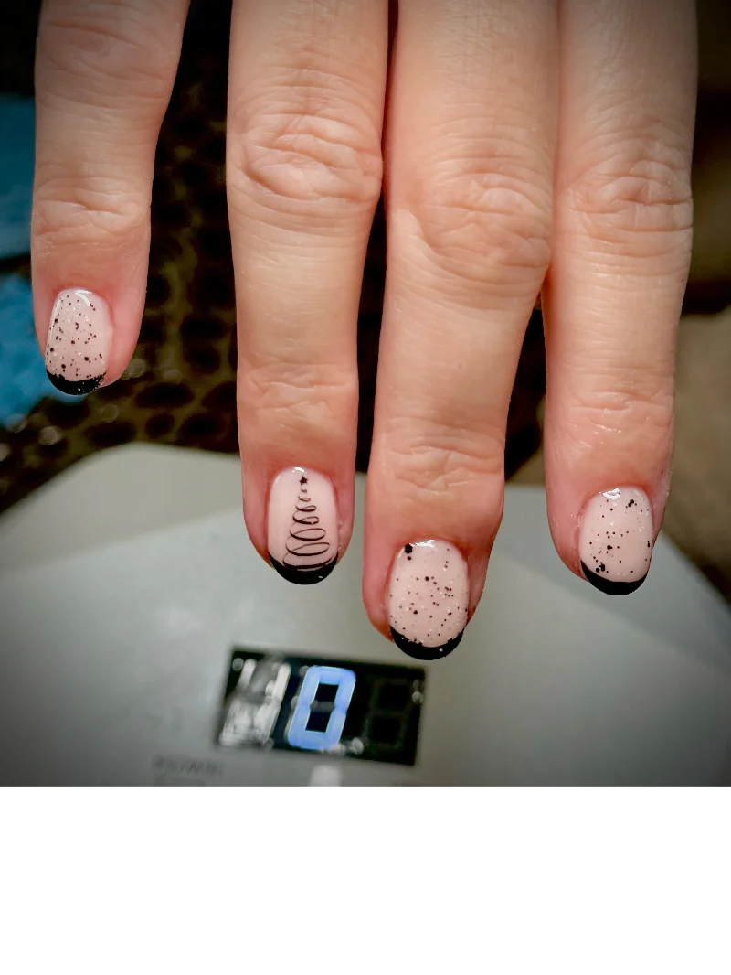 Nude nails with black Christmas tree design