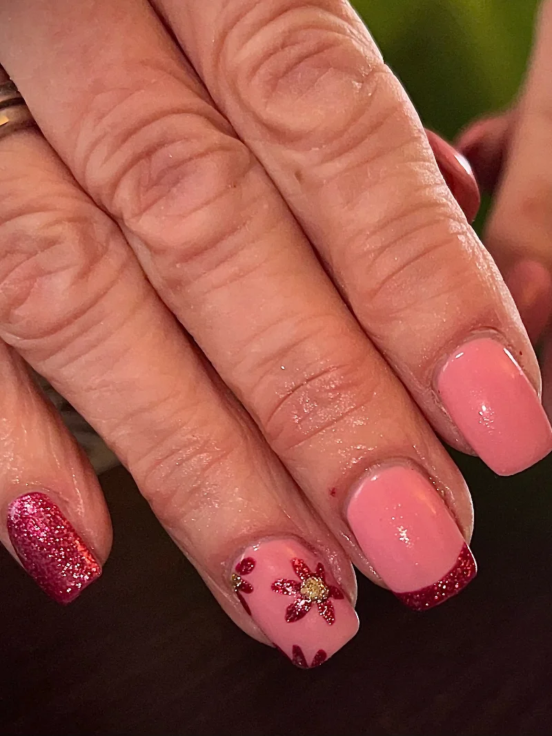 Pink and red glitter nails with flower detail