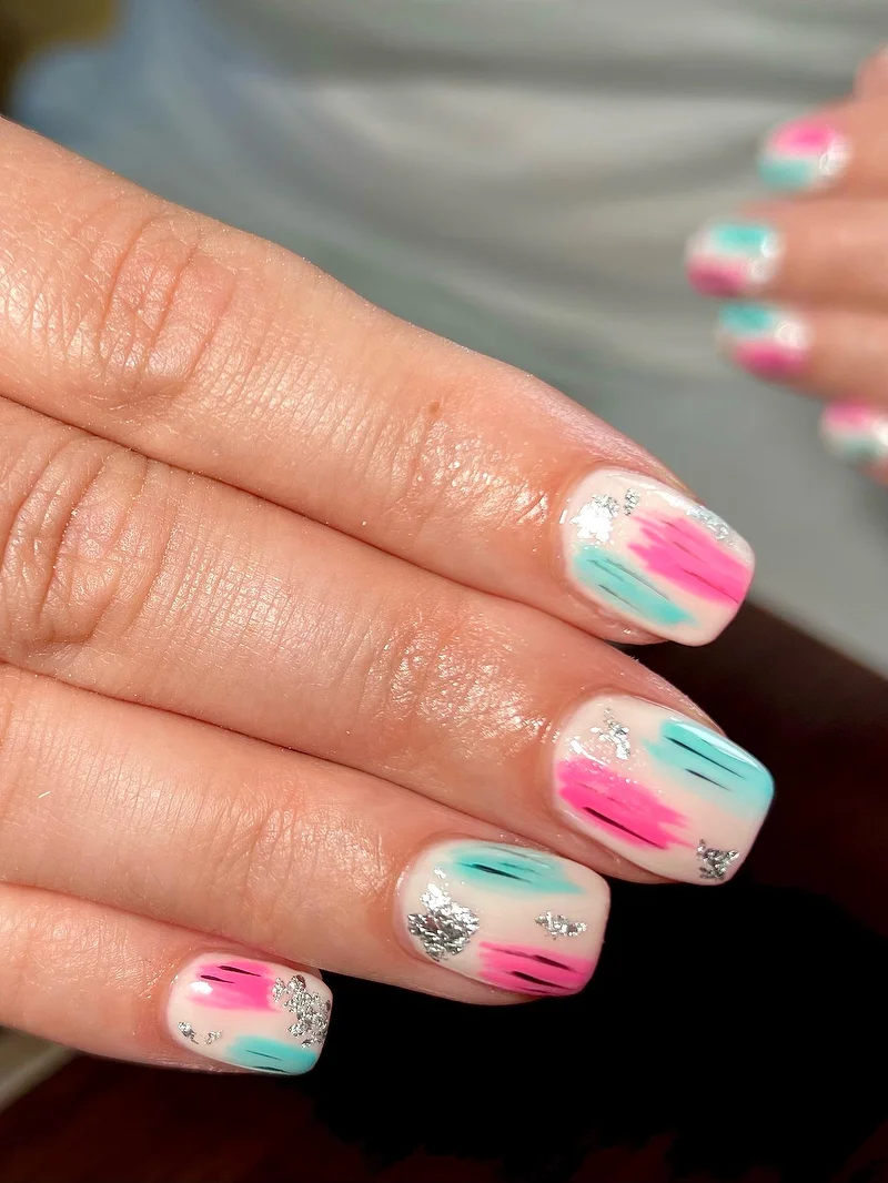Pink and teal brushstroke nails with foil
